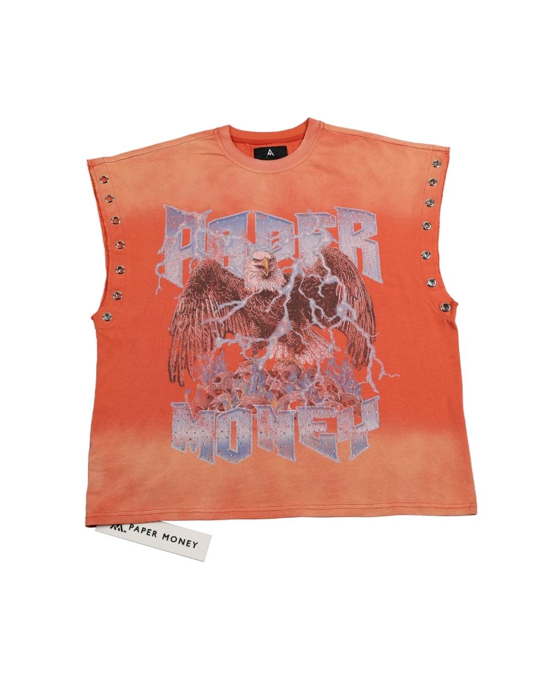 An orange sleeveless crop top by Paper Money, featuring a distressed eagle graphic with lightning effects and silver metal studs along the shoulders, shown flat on a white background with its paper tag visible.