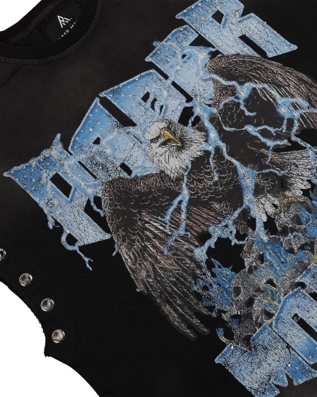 Close-up of a black graphic t-shirt featuring a distressed blue and silver eagle design with lightning effects and the word 'FEAR' in stylized blue letters.