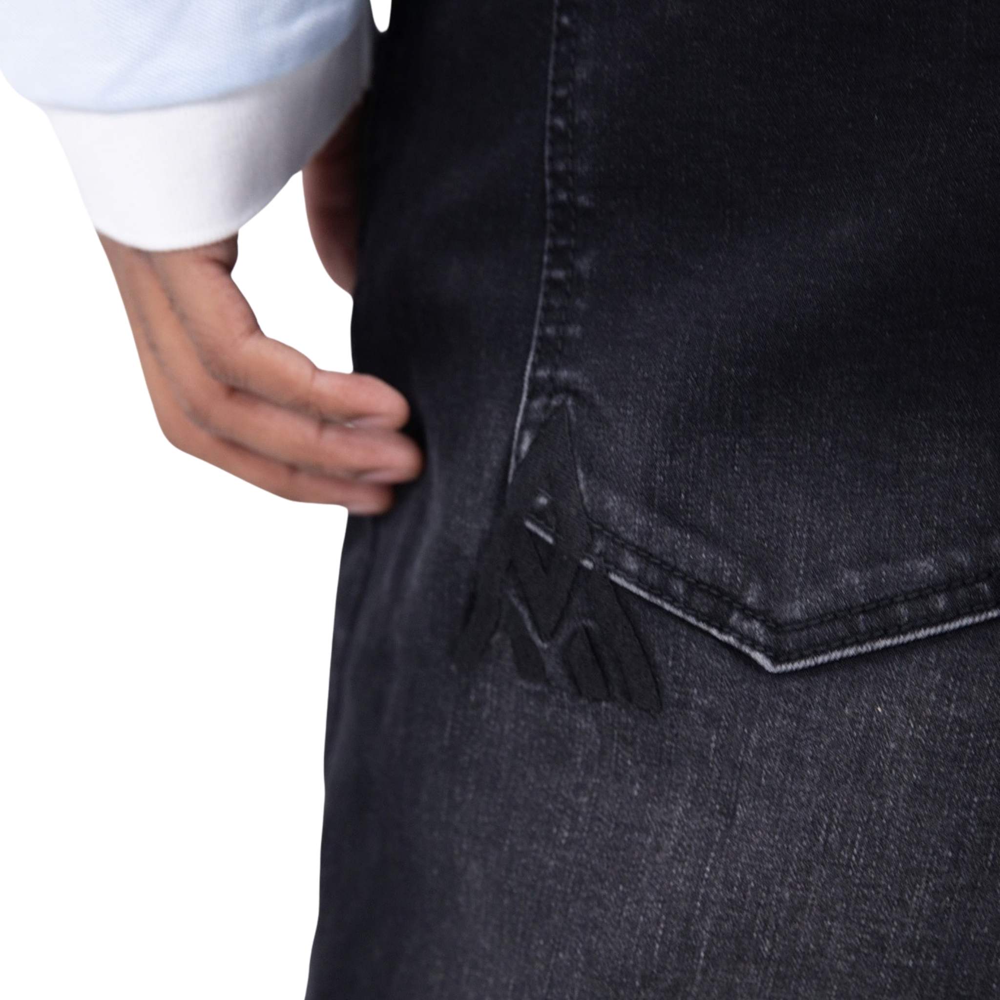 Close-up of dark blue jeans with a white background