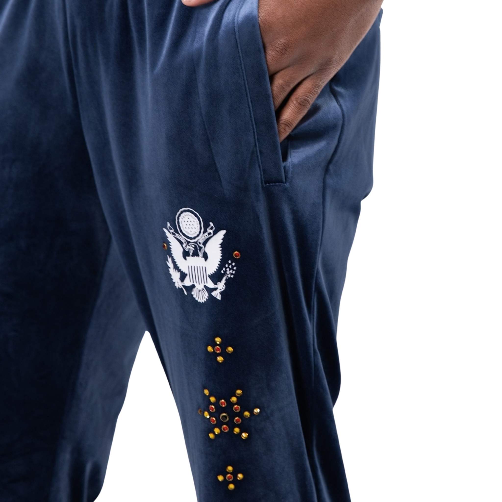 Velour fabric with stud detailing on blue track pants