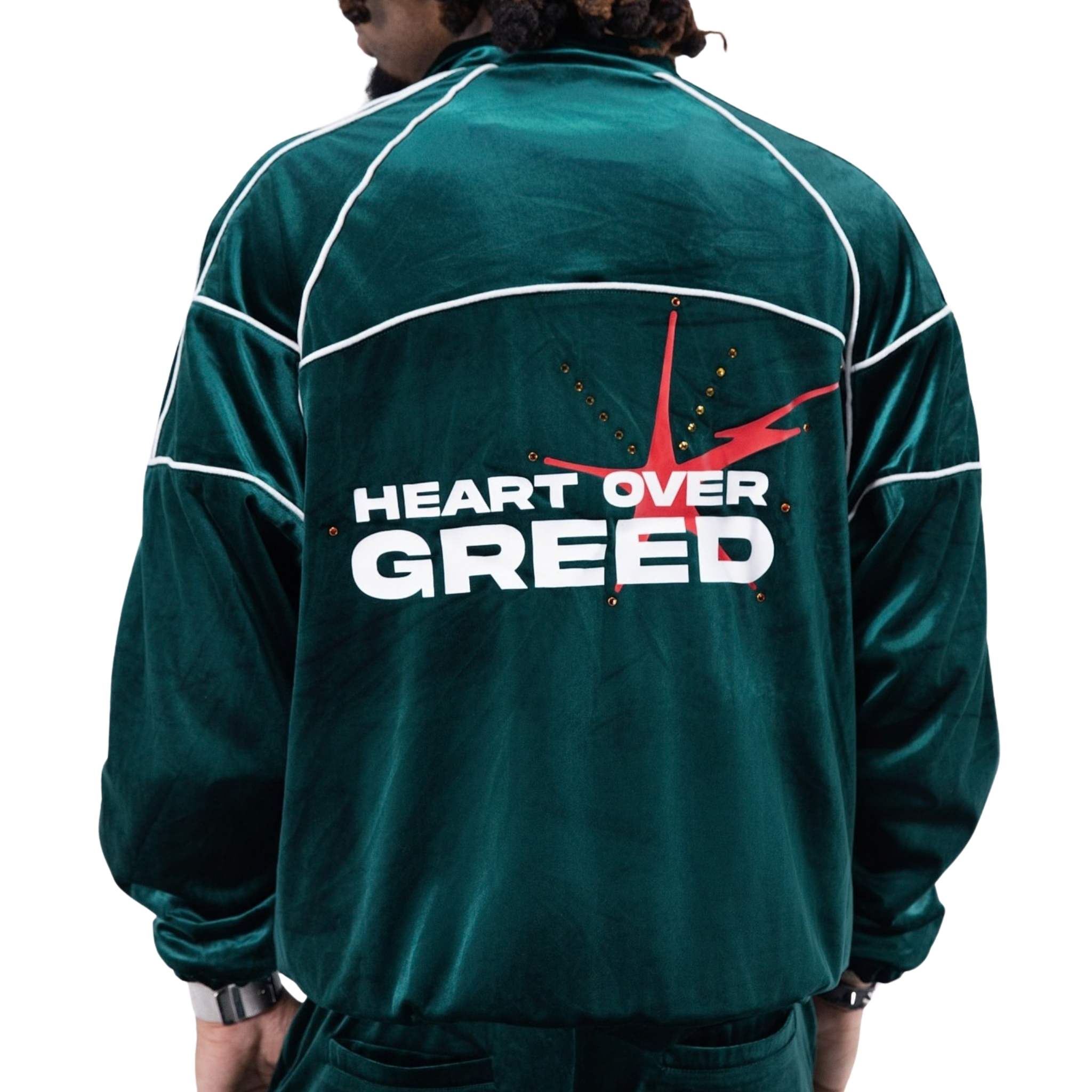 Emerald velour jacket with “Heart Over Greed” graphic and stud detailing