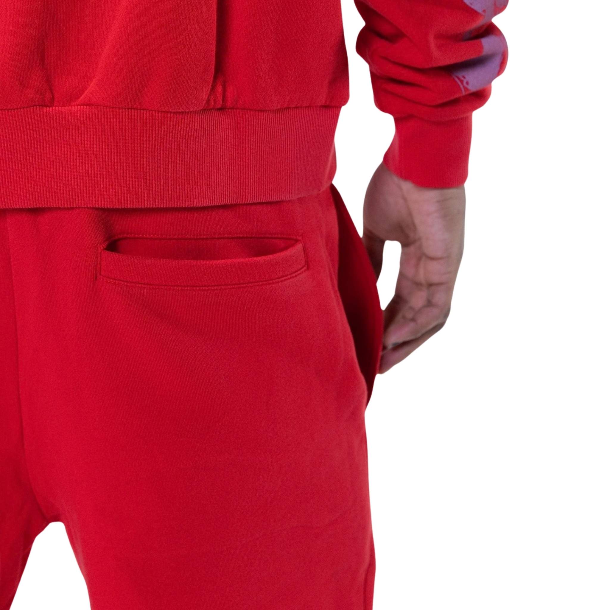 Printed artwork detail on red fleece joggers