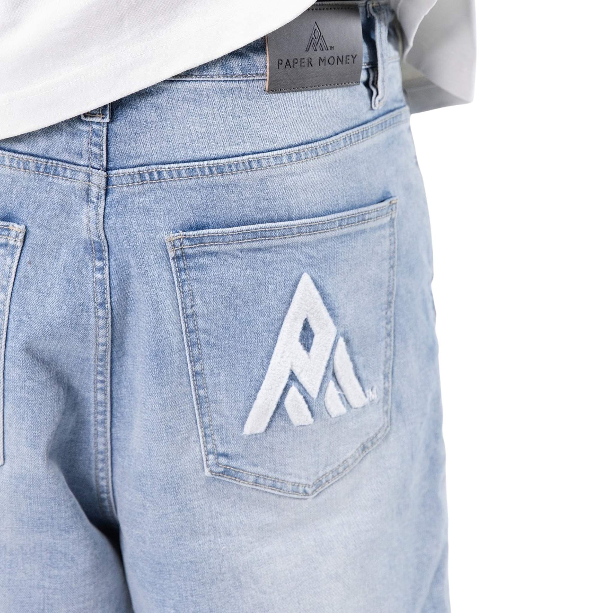 Light blue jeans with a brand logo on the pocket against a white background