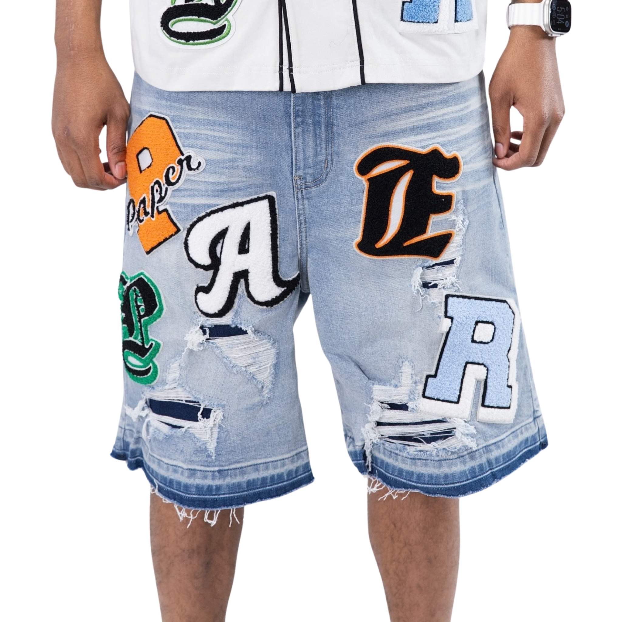 Blue denim shorts with patch graphics and distressing – front view